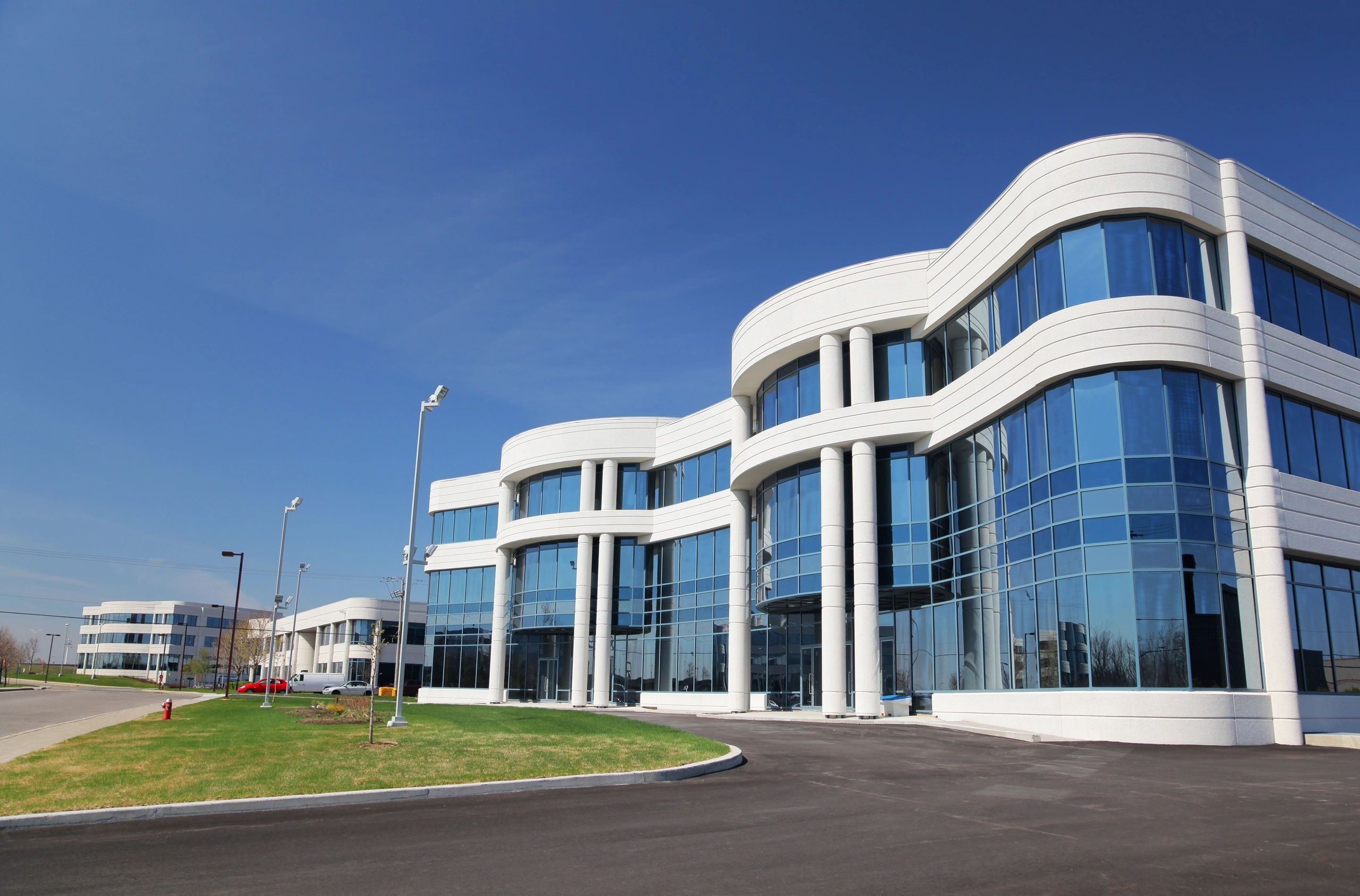 Modern white curved office building exterior